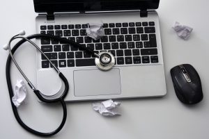 laptop with stethoscope - chiropractic services