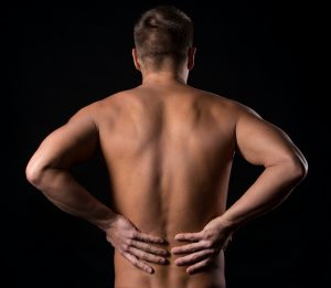 guy with pain in the back - chiropractic care